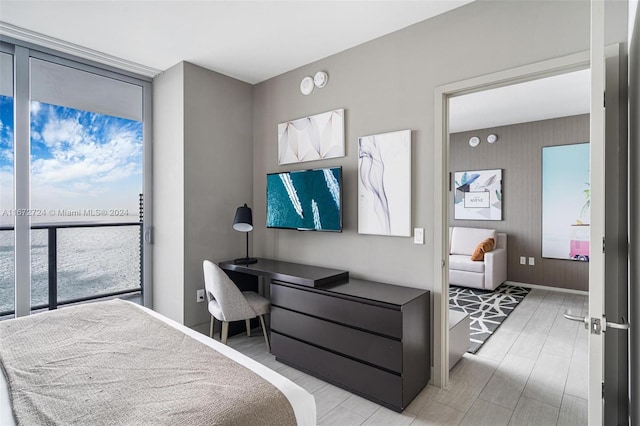 bedroom with built in desk and light hardwood / wood-style floors