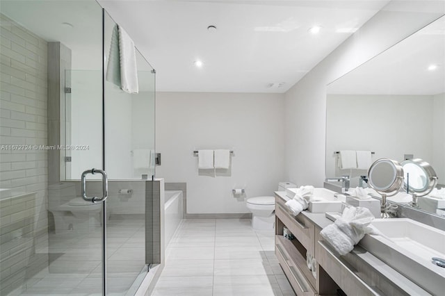 full bathroom featuring tile patterned floors, toilet, vanity, and shower with separate bathtub