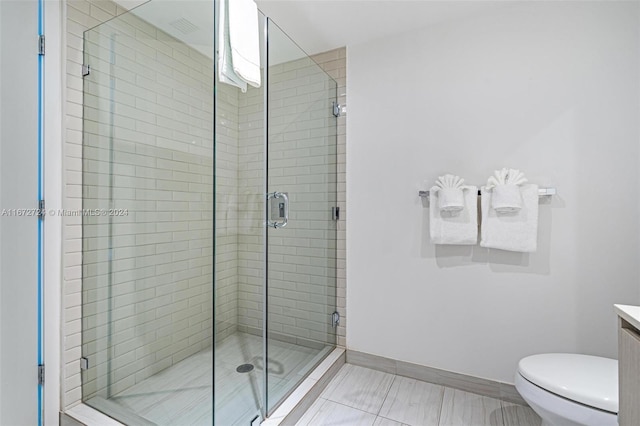 bathroom with tile patterned flooring, toilet, walk in shower, and vanity