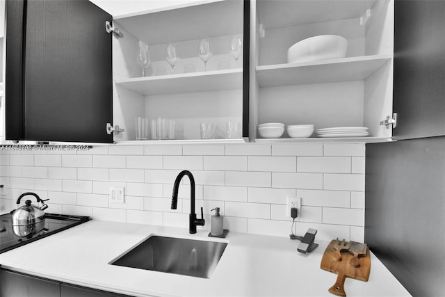 room details featuring tasteful backsplash and sink