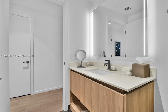 bathroom featuring hardwood / wood-style floors and vanity