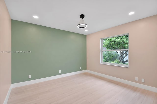 unfurnished room with light hardwood / wood-style floors