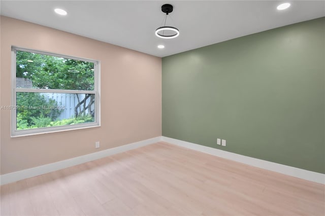 unfurnished room with light wood-type flooring