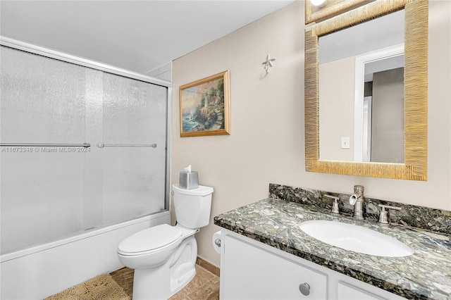 full bathroom featuring vanity, toilet, and bath / shower combo with glass door