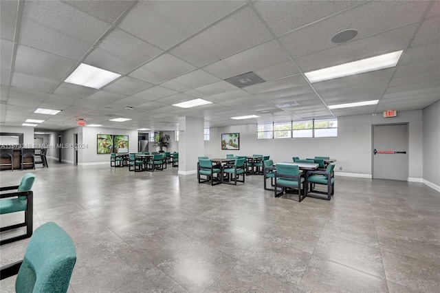 interior space with a paneled ceiling