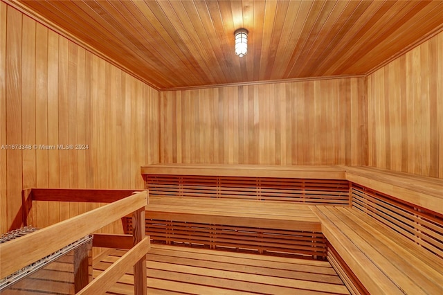 view of sauna featuring wooden ceiling, wooden walls, and hardwood / wood-style floors