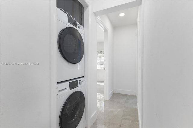 washroom with stacked washing maching and dryer