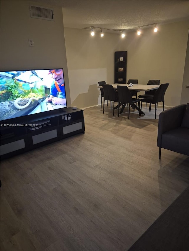 living room with hardwood / wood-style floors and a textured ceiling