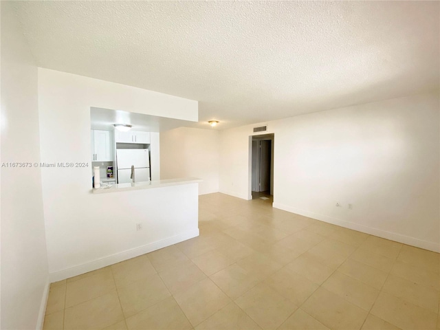 spare room with a textured ceiling