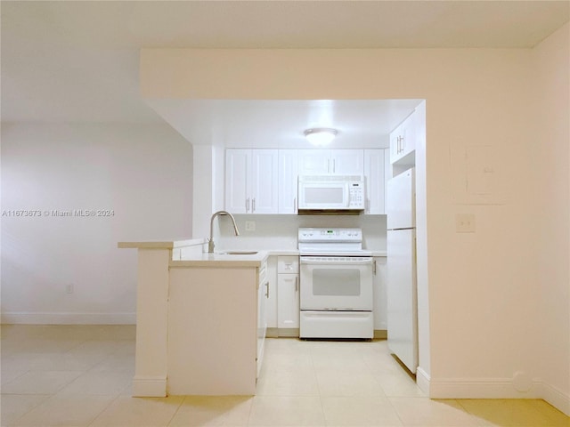 kitchen featuring light tile patterned flooring, white cabinetry, white appliances, and sink