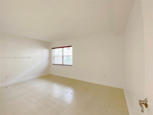 unfurnished room with light tile patterned floors