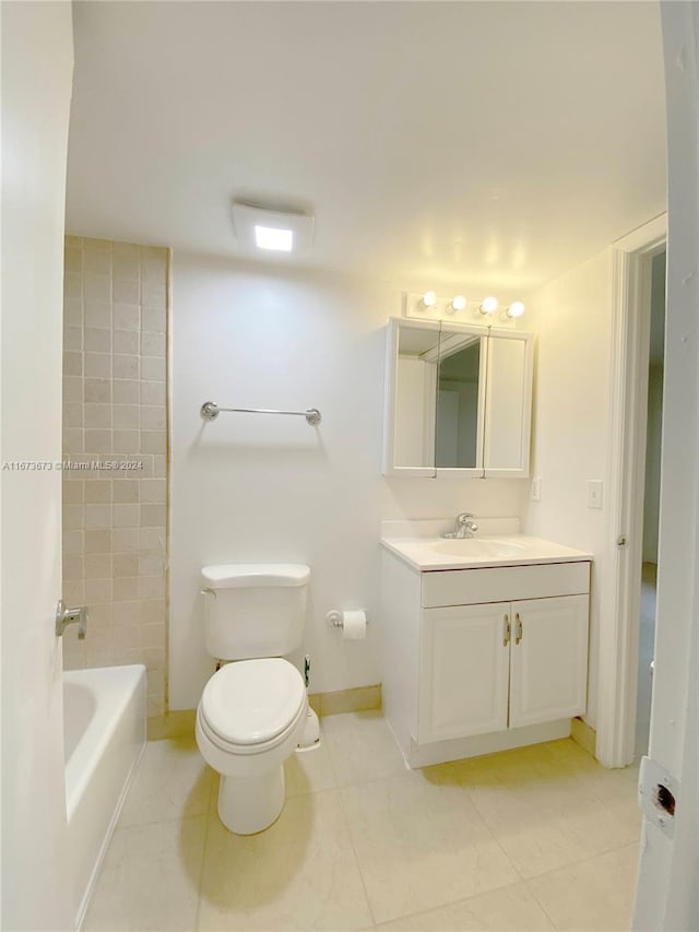 bathroom featuring vanity, tile patterned flooring, and toilet