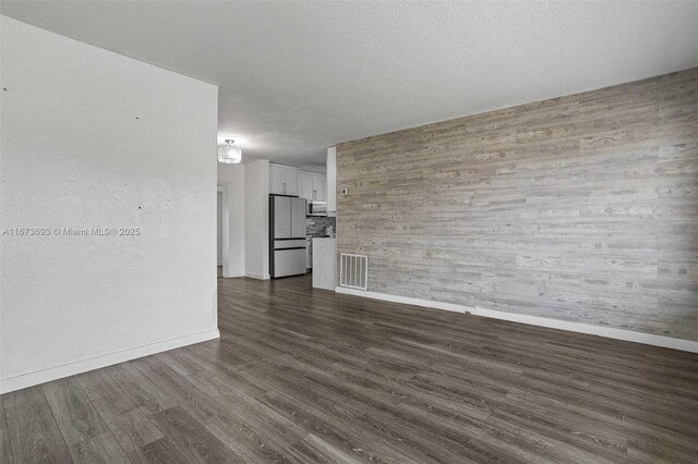 living room with dark hardwood / wood-style flooring and a textured ceiling