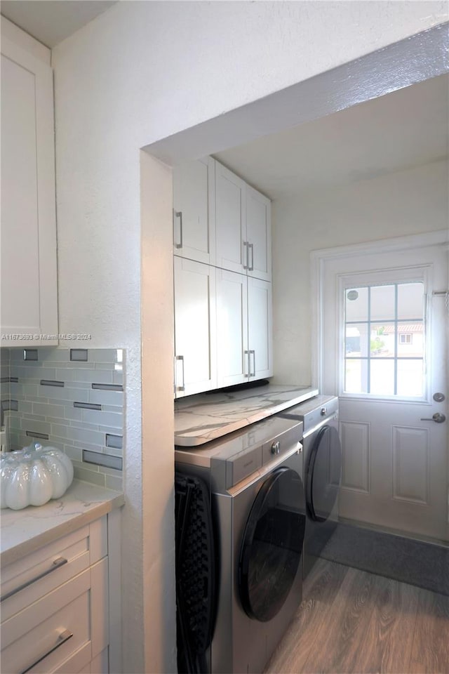 washroom featuring cabinets, separate washer and dryer, and dark hardwood / wood-style flooring