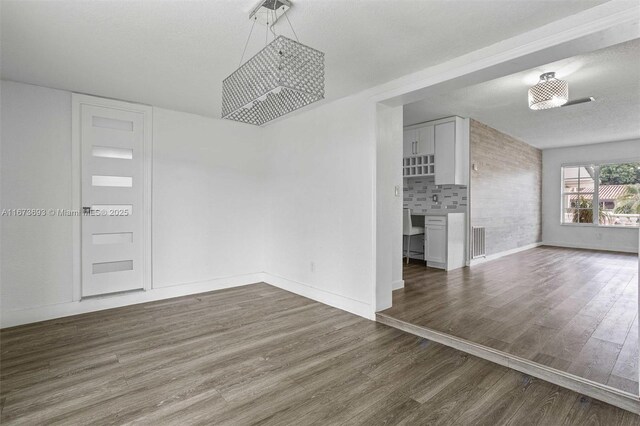 bedroom with ceiling fan, dark hardwood / wood-style floors, and a textured ceiling