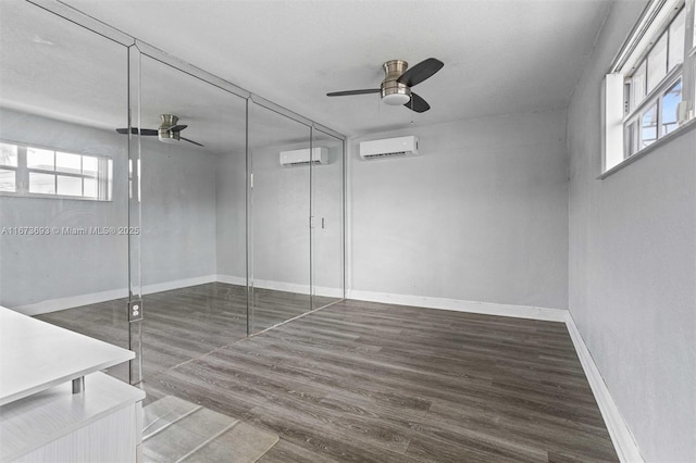 empty room with ceiling fan, plenty of natural light, and a wall mounted AC