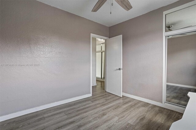 full bathroom with a shower stall, tile walls, toilet, and vanity