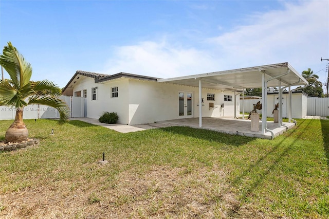 back of house featuring french doors, a lawn, a patio area, and fence