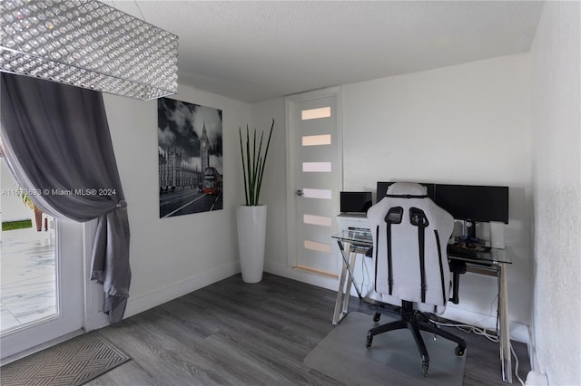 office area with a textured ceiling and hardwood / wood-style floors