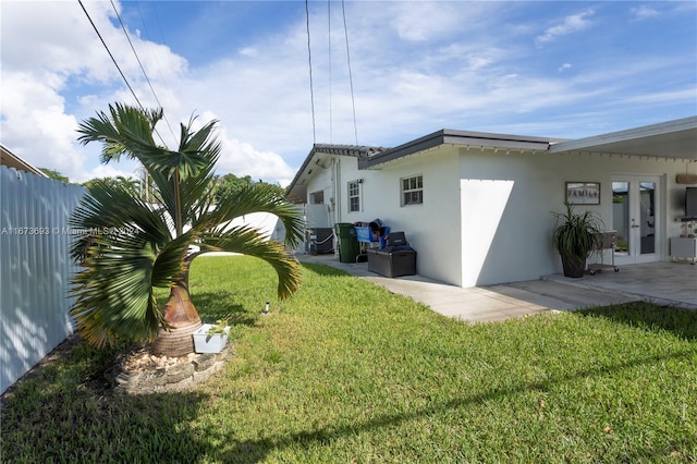 back of property featuring a yard and a patio area