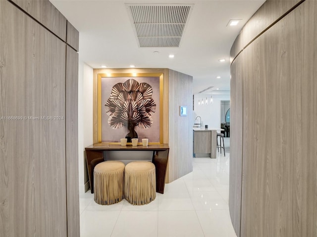 corridor featuring light tile patterned floors