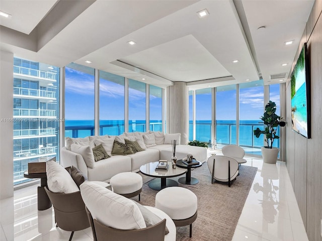 living room with a water view and expansive windows