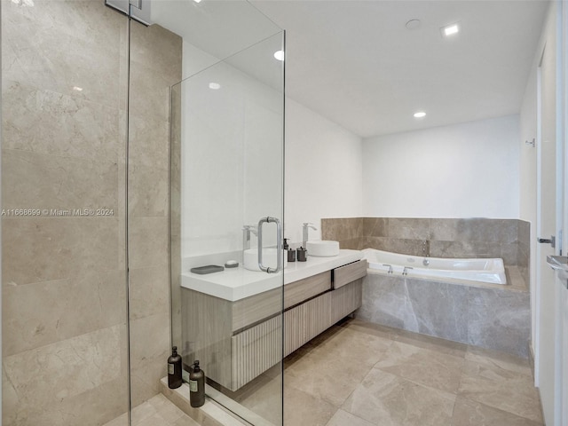 bathroom with independent shower and bath and vanity