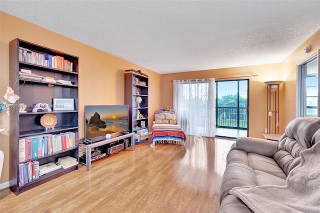 living room featuring hardwood / wood-style flooring, a textured ceiling, and a wealth of natural light