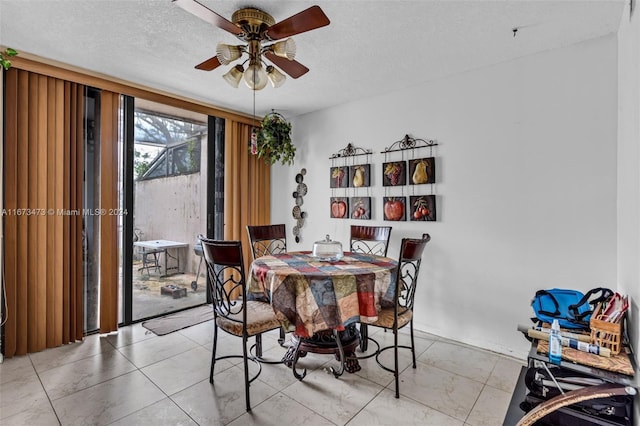 dining area with a textured ceiling and ceiling fan