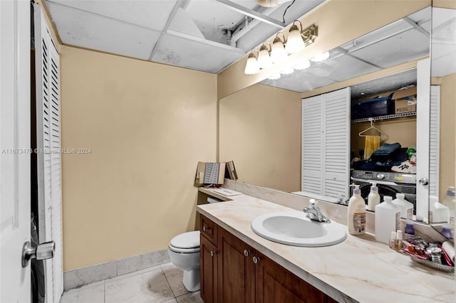 bathroom with tile patterned flooring, vanity, and toilet