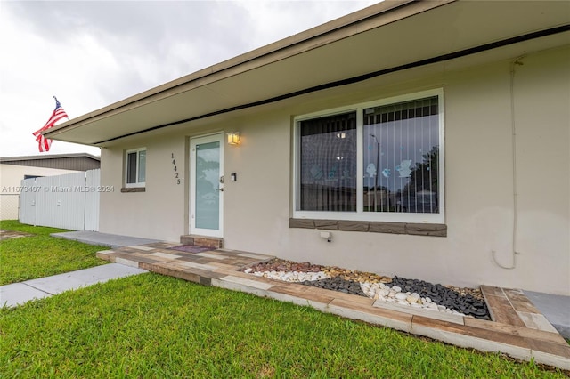 doorway to property with a yard