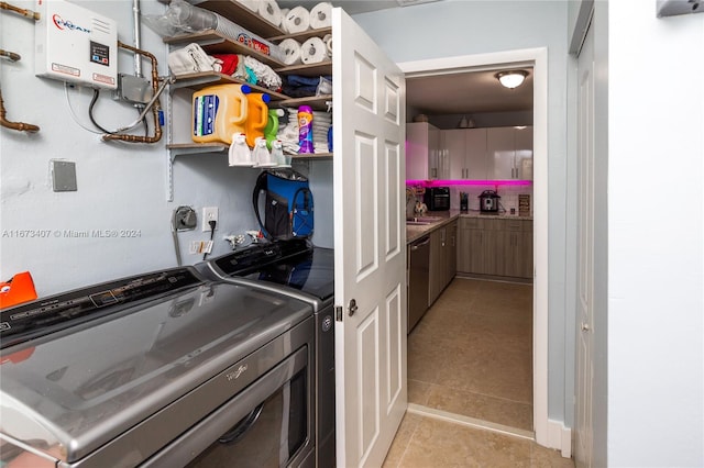 laundry room with light tile patterned flooring and washer and dryer