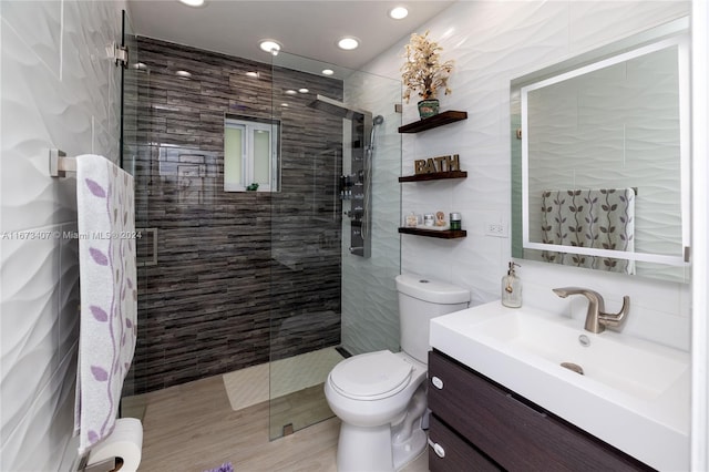 bathroom with vanity, tile walls, tile patterned flooring, an enclosed shower, and toilet