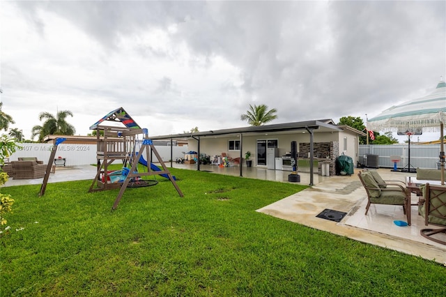 view of yard with a playground, a patio area, and central AC unit