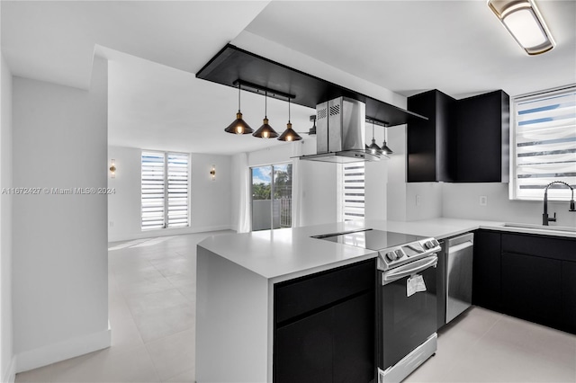 kitchen with kitchen peninsula, sink, stainless steel appliances, and ventilation hood