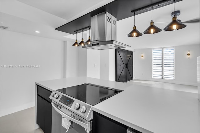 kitchen featuring exhaust hood, pendant lighting, and stainless steel electric range