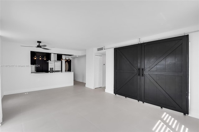 unfurnished living room with ceiling fan