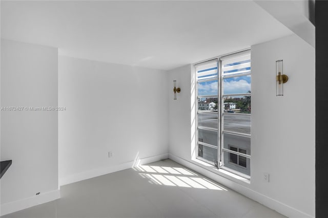 unfurnished room with floor to ceiling windows