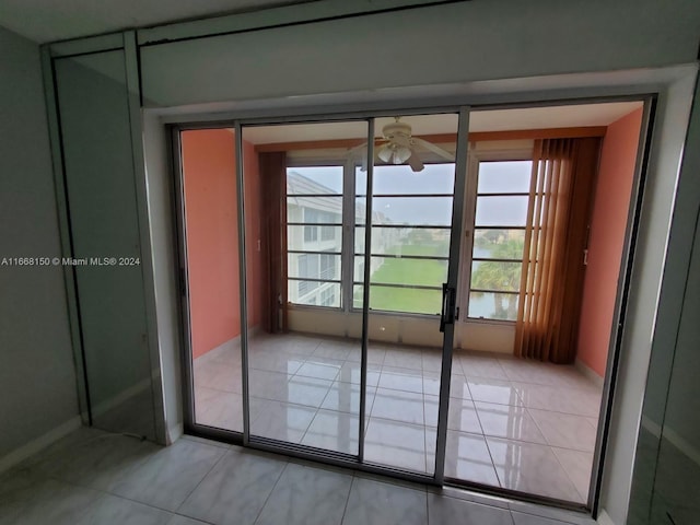 doorway to outside with ceiling fan, light tile patterned flooring, and plenty of natural light