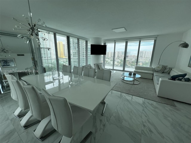 dining room with a wall of windows and an inviting chandelier