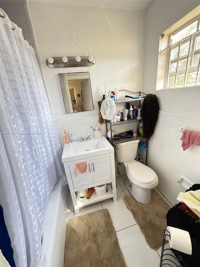 full bathroom with toilet, shower / tub combo, tile patterned flooring, and tile walls