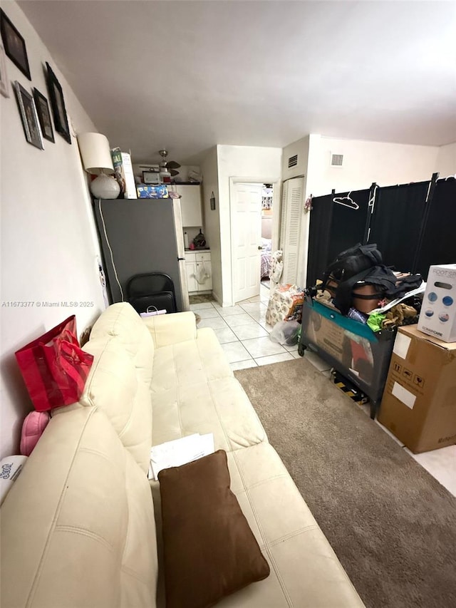 living room with light tile patterned floors and visible vents