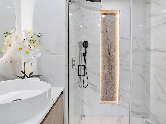 bathroom with vanity and a shower with door