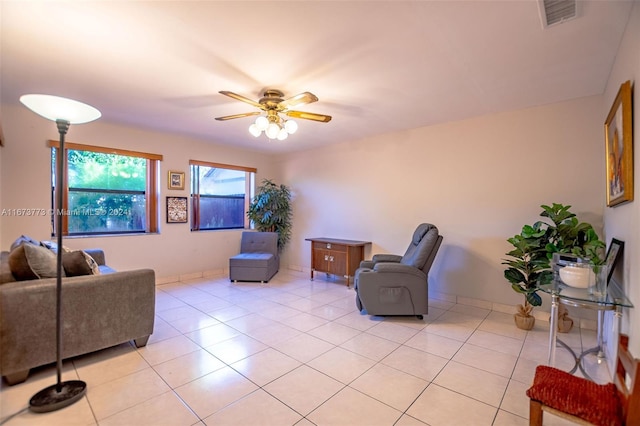 tiled living room featuring ceiling fan