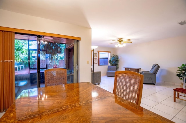 dining space with ceiling fan and light tile patterned floors