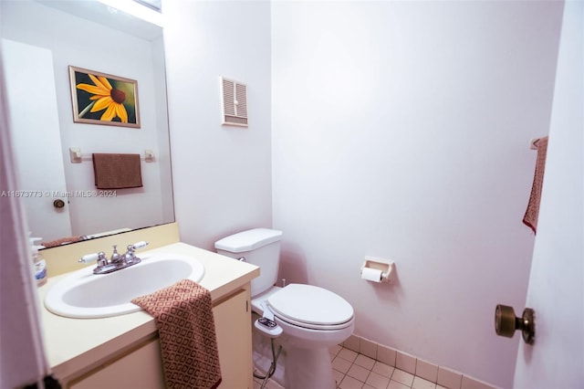 bathroom featuring vanity, tile patterned flooring, and toilet