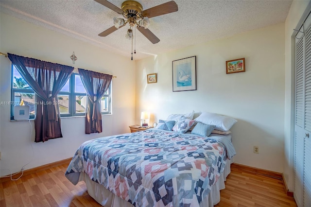 bedroom featuring a closet, light hardwood / wood-style floors, and ceiling fan