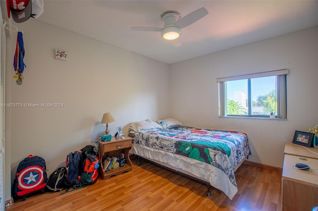 bedroom with hardwood / wood-style floors and ceiling fan