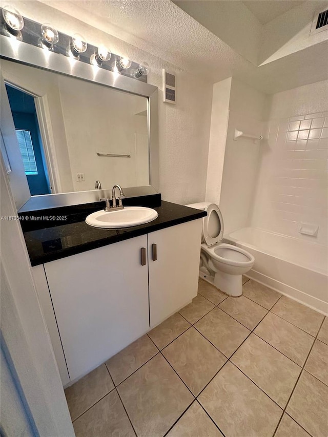 full bathroom with tile patterned floors, toilet, tub / shower combination, a textured ceiling, and vanity