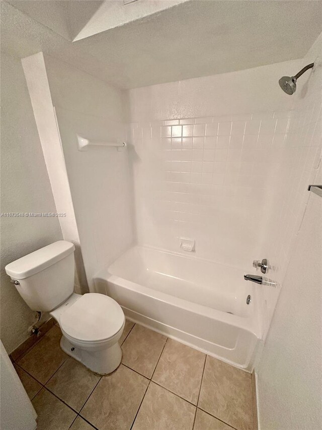 bathroom with tile patterned flooring, a tub, vanity, and toilet